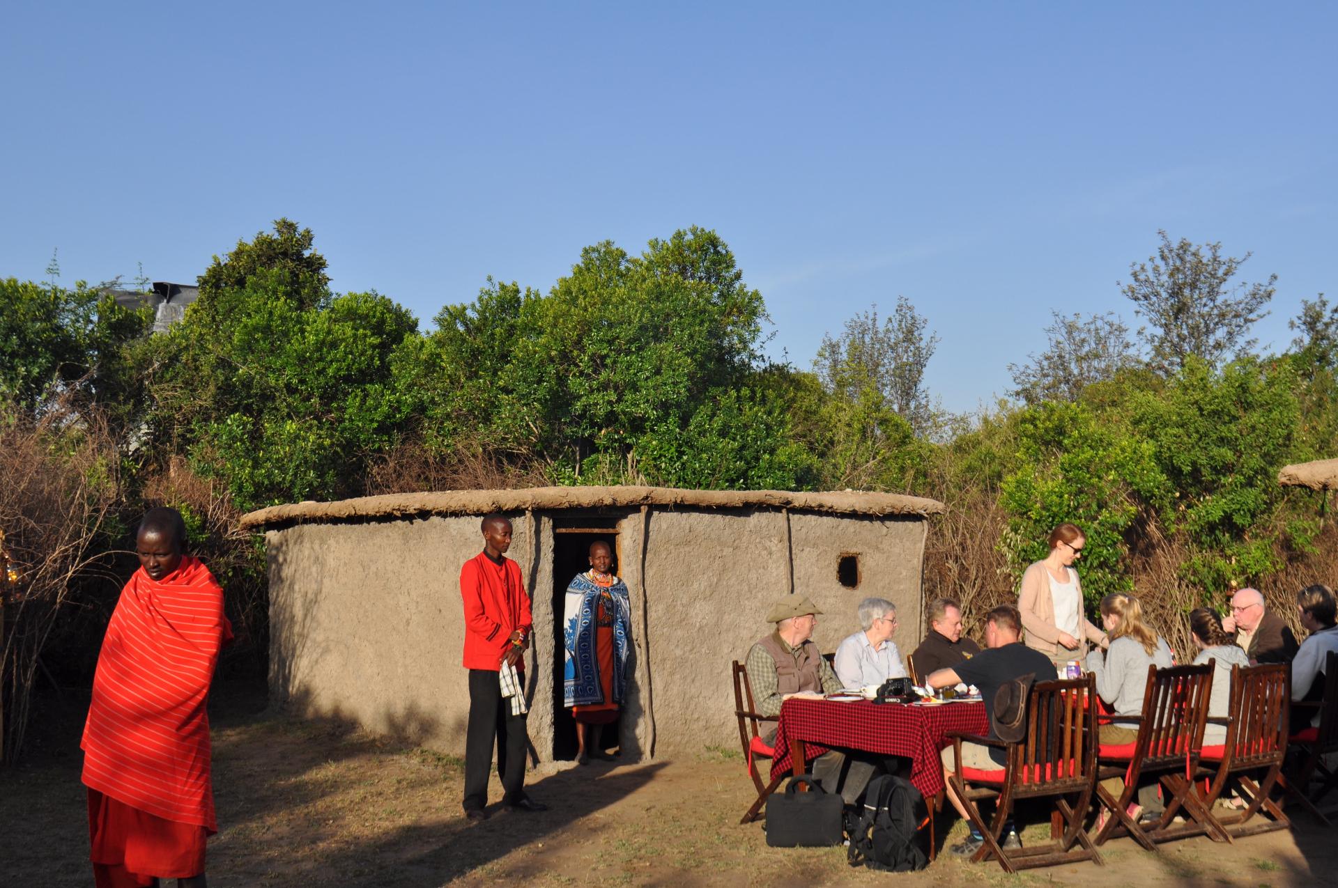 Guests dining at a traditional Masai village in the Mara