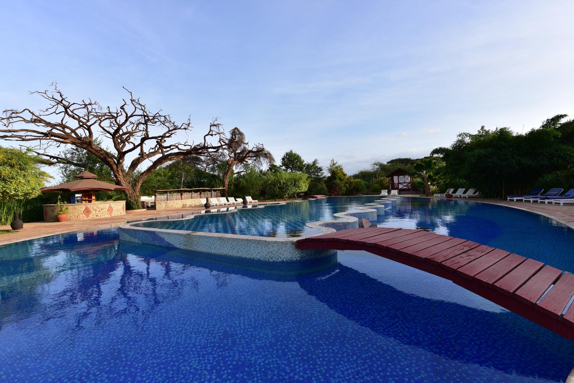 Swimming pool with wooden bridge at Kilima Safari Camp