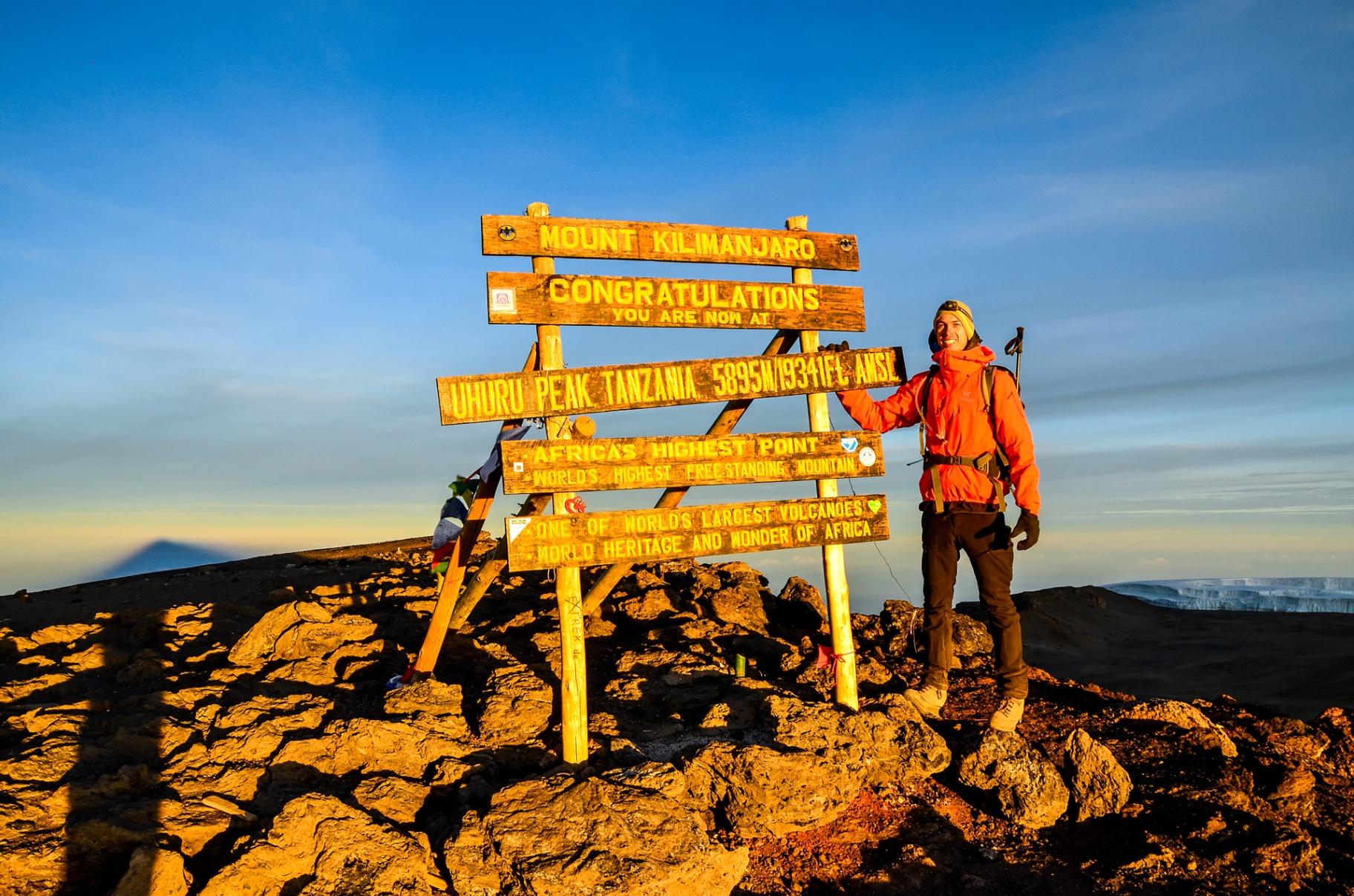 Hiker reaching the summit of Mount Kilimanjaro