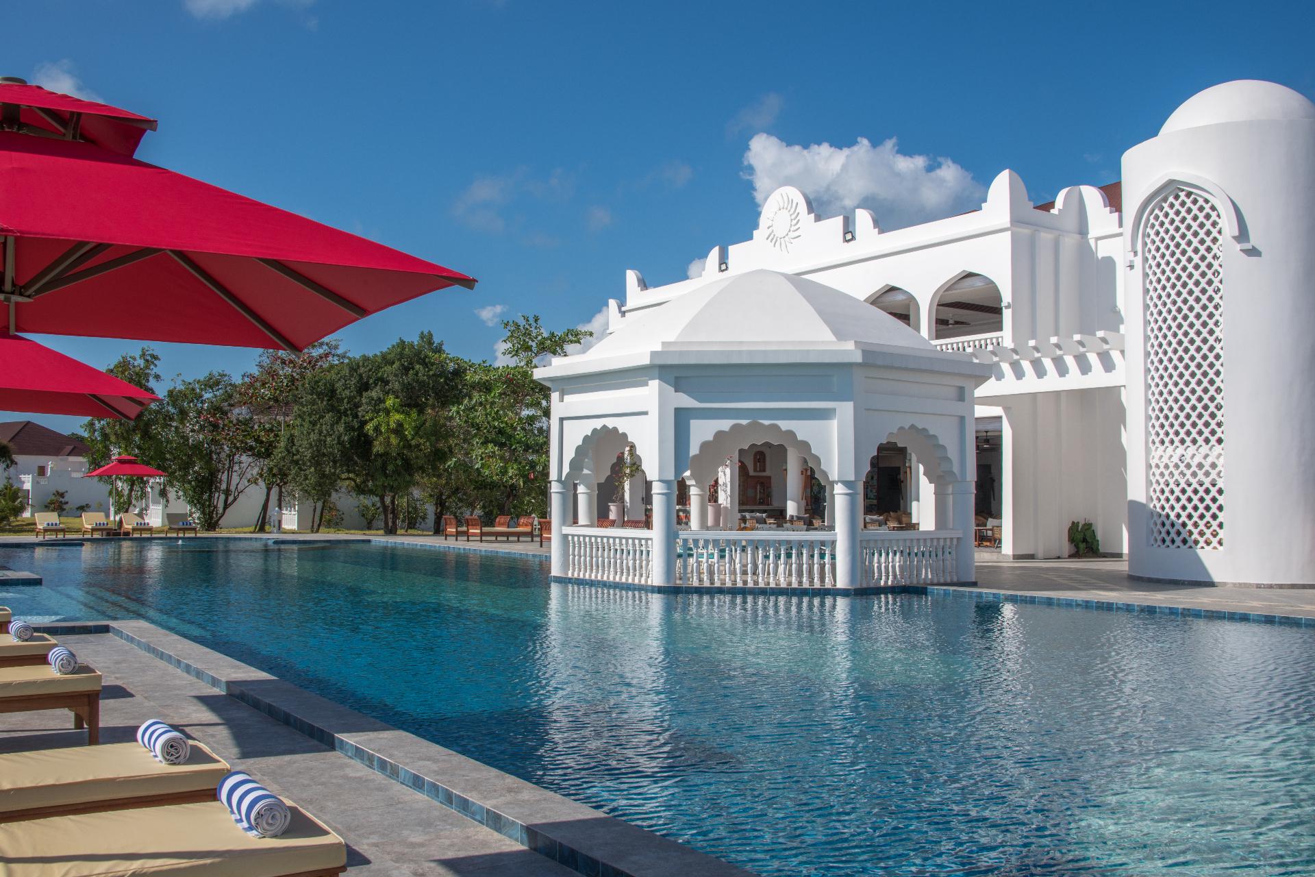 Elegant white gazebo in the center of a luxury resort pool