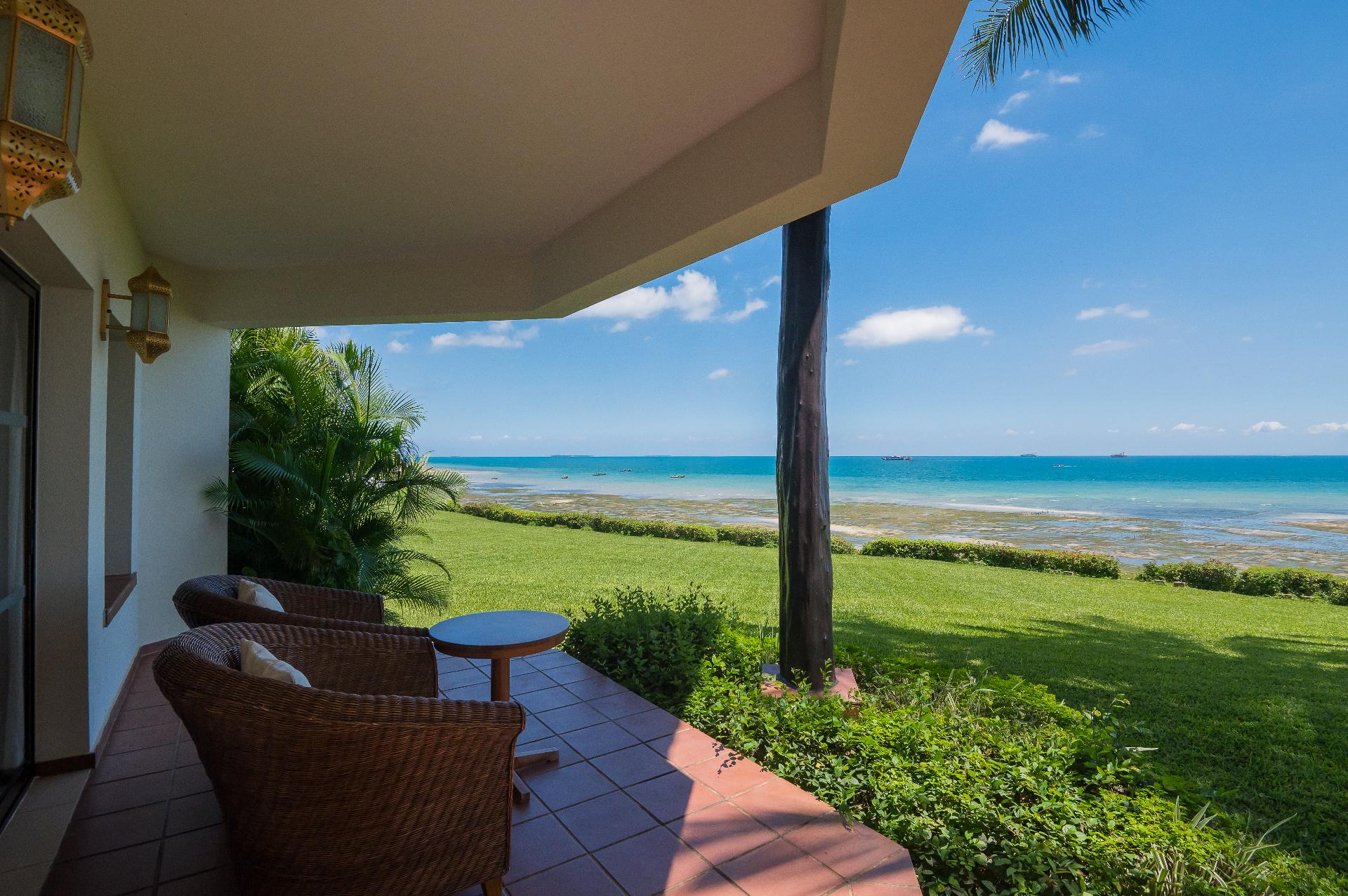 Private terrace with seating overlooking turquoise ocean waters