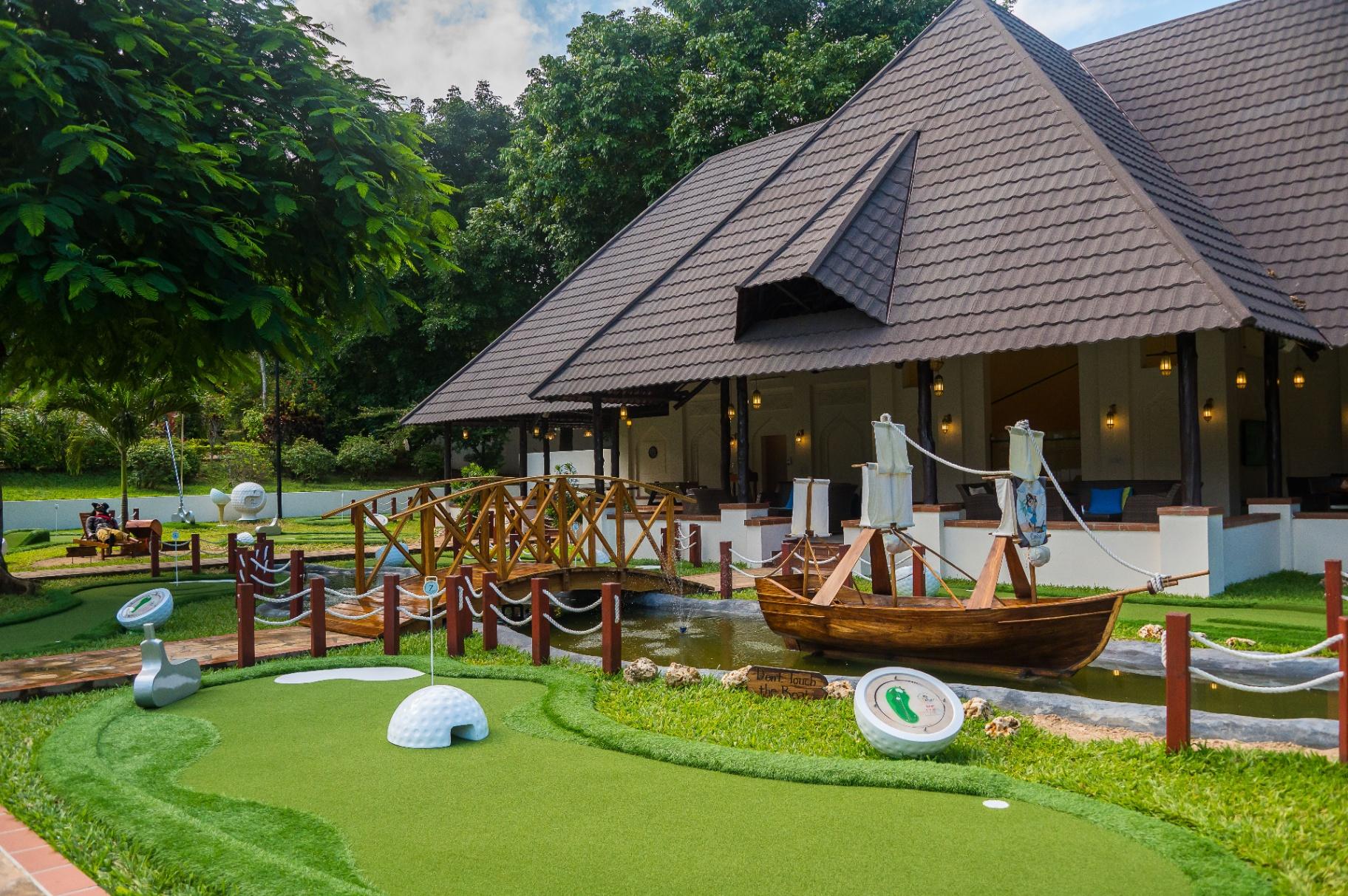 Mini golf course with boat feature at tropical resort